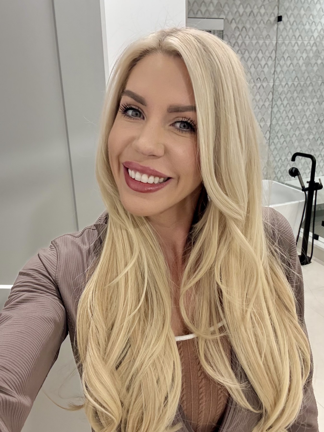 Smiling close-up portrait in a neutral top