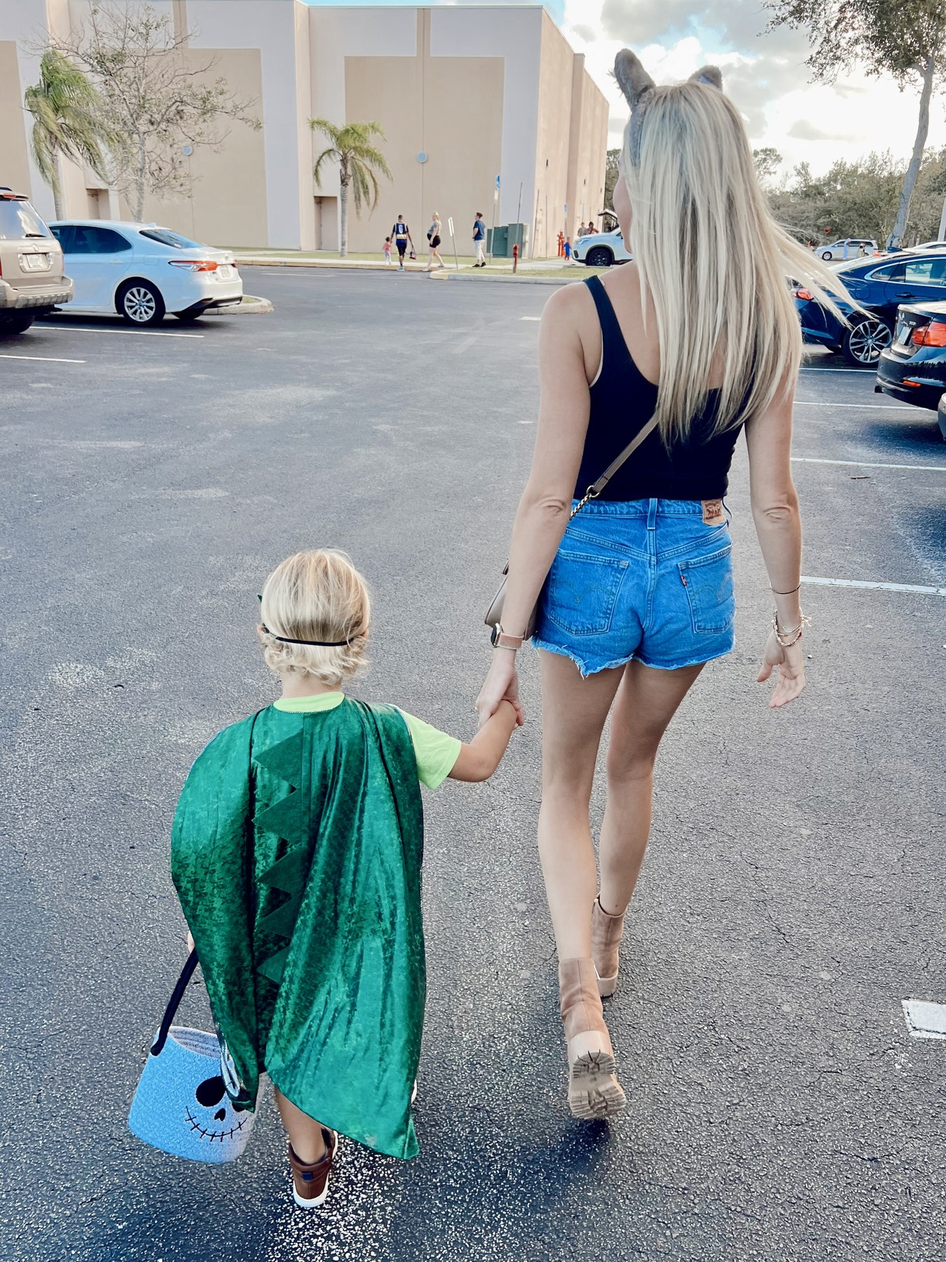 A woman and child walking hand in hand
